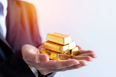 Midsection of woman holding gift box against white background