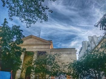 Low angle view of building against cloudy sky