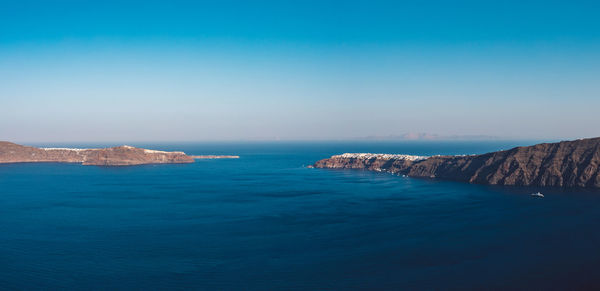 Scenic view of sea against clear blue sky