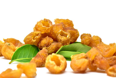 Close-up of serving food in plate against white background