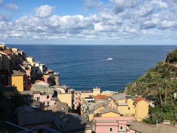 High angle view of townscape by sea against sky