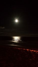 Scenic view of sea against sky at night