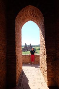 Woman seen through arch in historic building