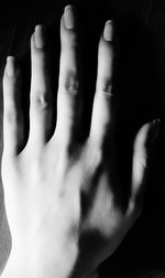 Close-up of hands against black background