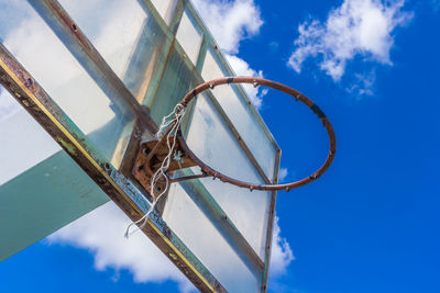 Low angle view of metallic structure against blue sky