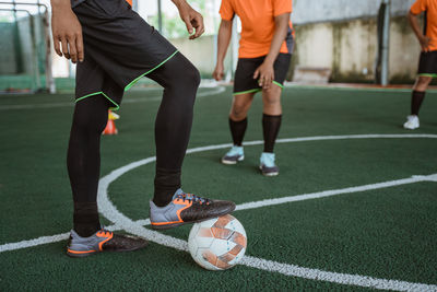 Low section of people playing football