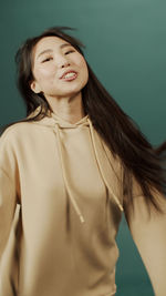 Smiling woman against blue background