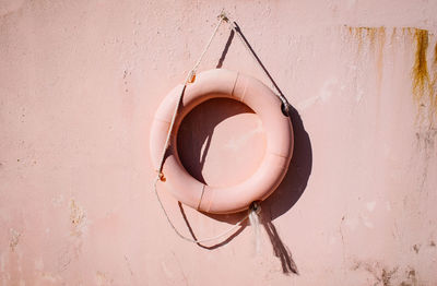 Lifebelt hanging on pink wall
