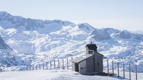 Small chapel on a snowy landscape surrounded by mountains, austria, europe