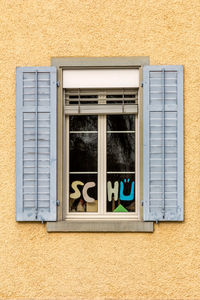 Low angle view of windows on wall of building