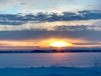 Scenic view of lake against sky during sunset