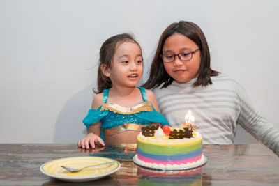 Little girl smiling and happy while celebrating at home with family during quarantine.