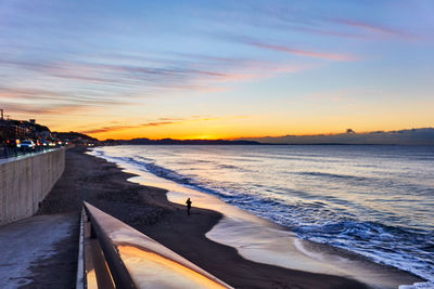 Scenic view of beach against sky during sunset