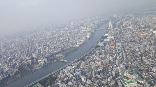 Aerial view of city and buildings against sky