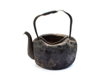 Close-up of black tea kettle against white background