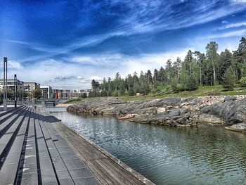 Scenic view of river against cloudy sky