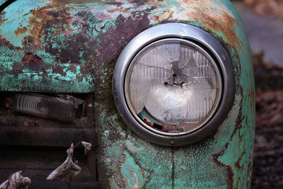 Headlight of an old rusty car.