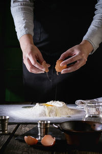 Midsection of man preparing food