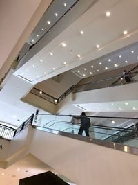 Low angle view of man walking on staircase