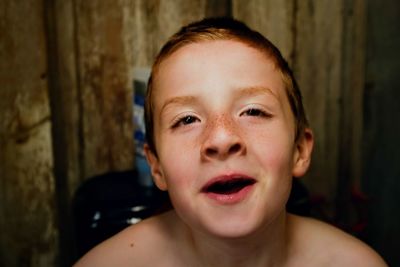 Close-up portrait of cute smiling boy at home