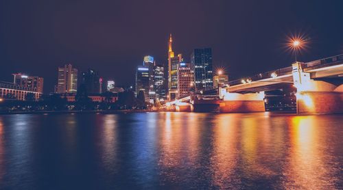 Illuminated city at waterfront