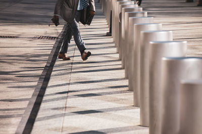 Low section of man walking on footpath