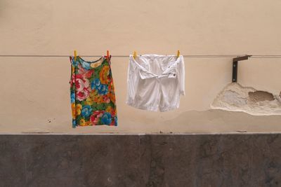 Clothes hanging against wall