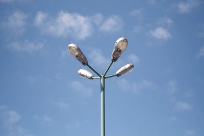 Low angle view of street light against cloudy sky