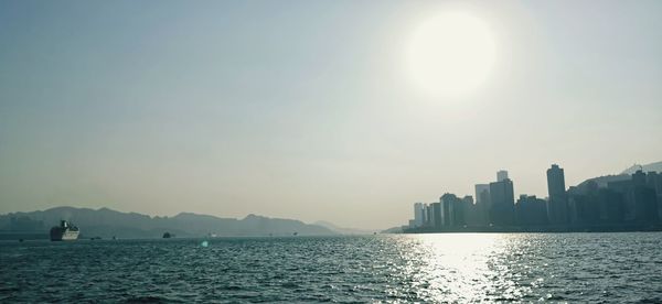 Scenic view of sea and buildings against sky