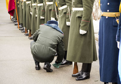 Rare view of officer wiping soldier shoe