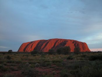 Scenic view of rocks on field against sky