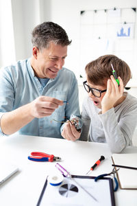 Boy looking at camera on table