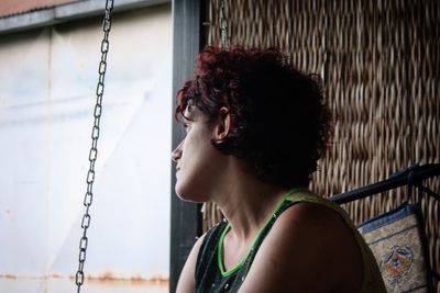 Close-up of young woman sitting on swing