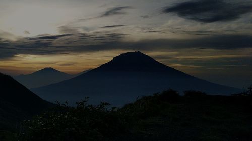 Scenic view of silhouette mountains against sky during sunset