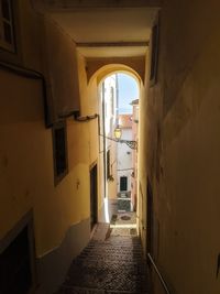 Empty alley amidst buildings in city