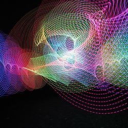 Close-up of illuminated light painting against black background