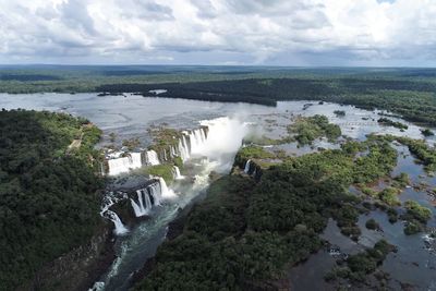 High angle view of river amidst trees against sky