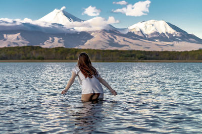Full length of woman in lake against mountains