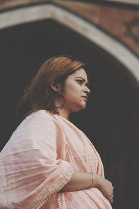 Portrait of a young woman looking away