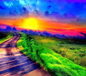 Scenic view of rainbow over field against sky