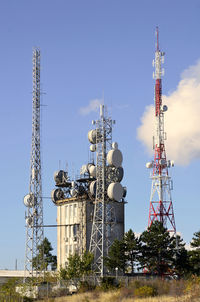 Low angle view of communications tower against sky