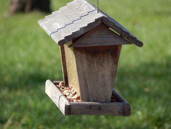 Close-up of birdhouse on field