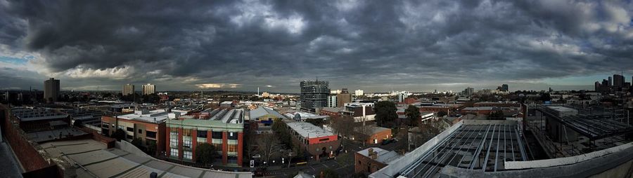 Buildings against cloudy sky