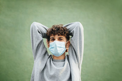 Portrait of man wearing mask against white background