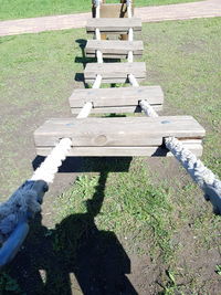 High angle view of park bench on field