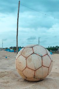 Close-up of soccer ball on beach