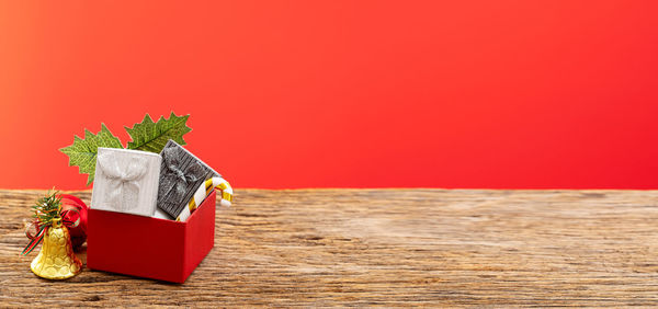 Close-up of red chili pepper on table against orange background