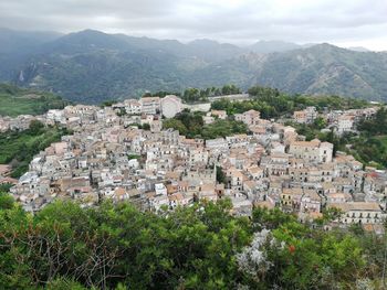 High angle view of townscape and mountains against sky