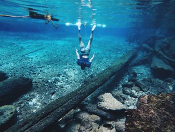 Low section of man swimming in sea