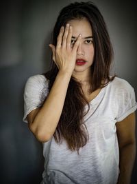 Portrait of beautiful young woman standing at home